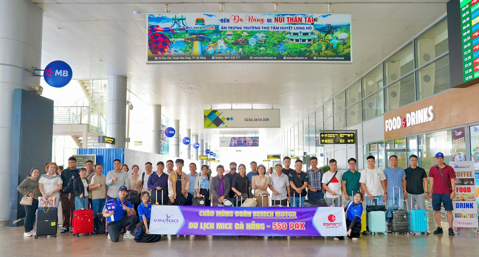 A group of people standing in a hallway 
Description automatically generated